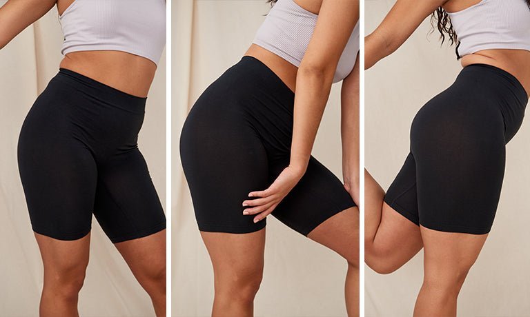 Front, side, and back views of black form-fitting anti-chafing shorts on model showing high-rise waistband and mid-thigh length