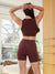 Rear view of Cargo 5-inch raisin slip shorts on model showing side cargo pocket and high-rise fit in sunlit room