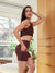 Side view of The Cargo 5-inch Raisin slip shorts on model showcasing thigh cargo pocket and high-rise fit in a sunlit room