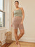 Front view of Taupe Cargo 7 inch anti chafe biker shorts on model, high rise fit with side pocket in neutral room