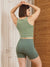 Rear view of The Cargo 5-inch sage shorts on model showing side cargo pocket and mid-rise fit against wood and door