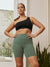 Front view of The Cargo 7-inch sage shorts on model with high-rise waistband, cargo pockets, and fitted length