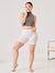 Front view of The Cooling 5-inch Halo shorts in white on a model showing high-rise waist, 5-inch thigh length, and smooth fit on a light studio background