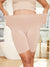 Front view of The Original 7-inch Almond slip shorts on model showcasing stretch waistband and mid-thigh fit in a bright bathroom