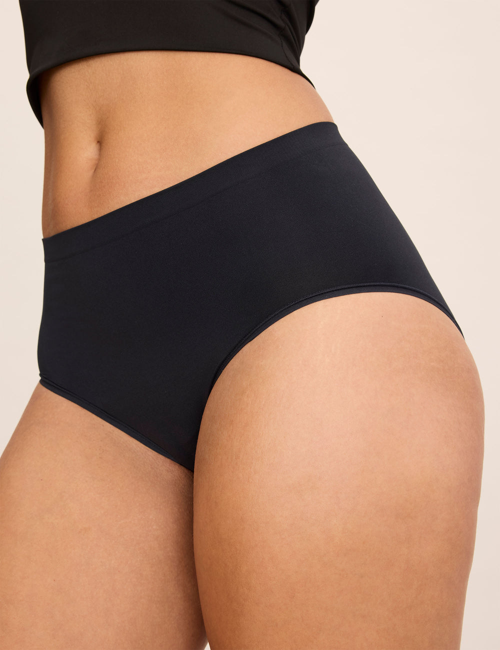 Close-up rear view of the black WhispAir Cooling Brief showcasing full coverage on a model against a light background