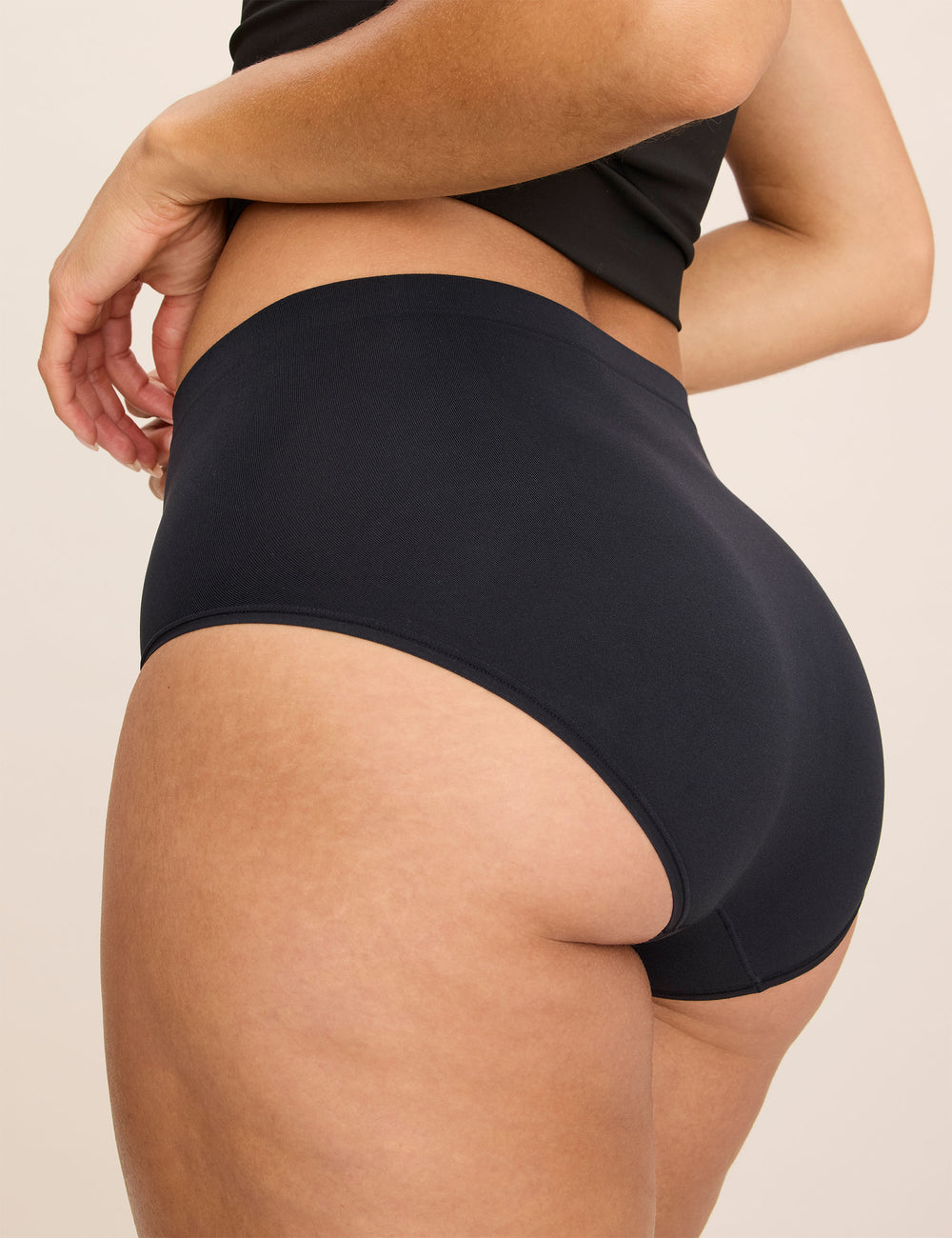 Rear three-quarter view of black WhispAir Cooling Brief showing high waist and full coverage on a model