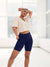 Front view of Original 9-inch navy anti-chafe shorts with high-rise waistband and fitted coverage on model in bright studio