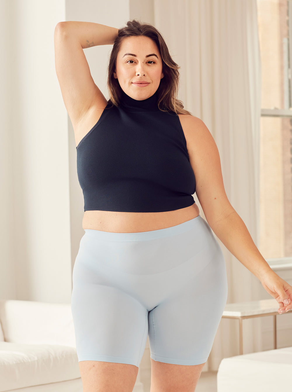 Front view of Cooling 9-inch Chambray anti-chafe shorts showing blue cooling fabric and waistband on model in room