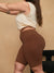 Side view of Cooling 9-inch anti-chafe shorts in cocoa on model, high-rise fit showing thigh coverage and smooth fabric, beige background